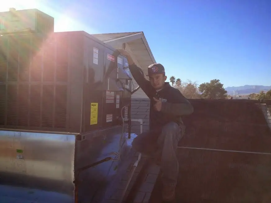 HVAC technician performing AC Tune-Up on a rooftop unit in Cocoa